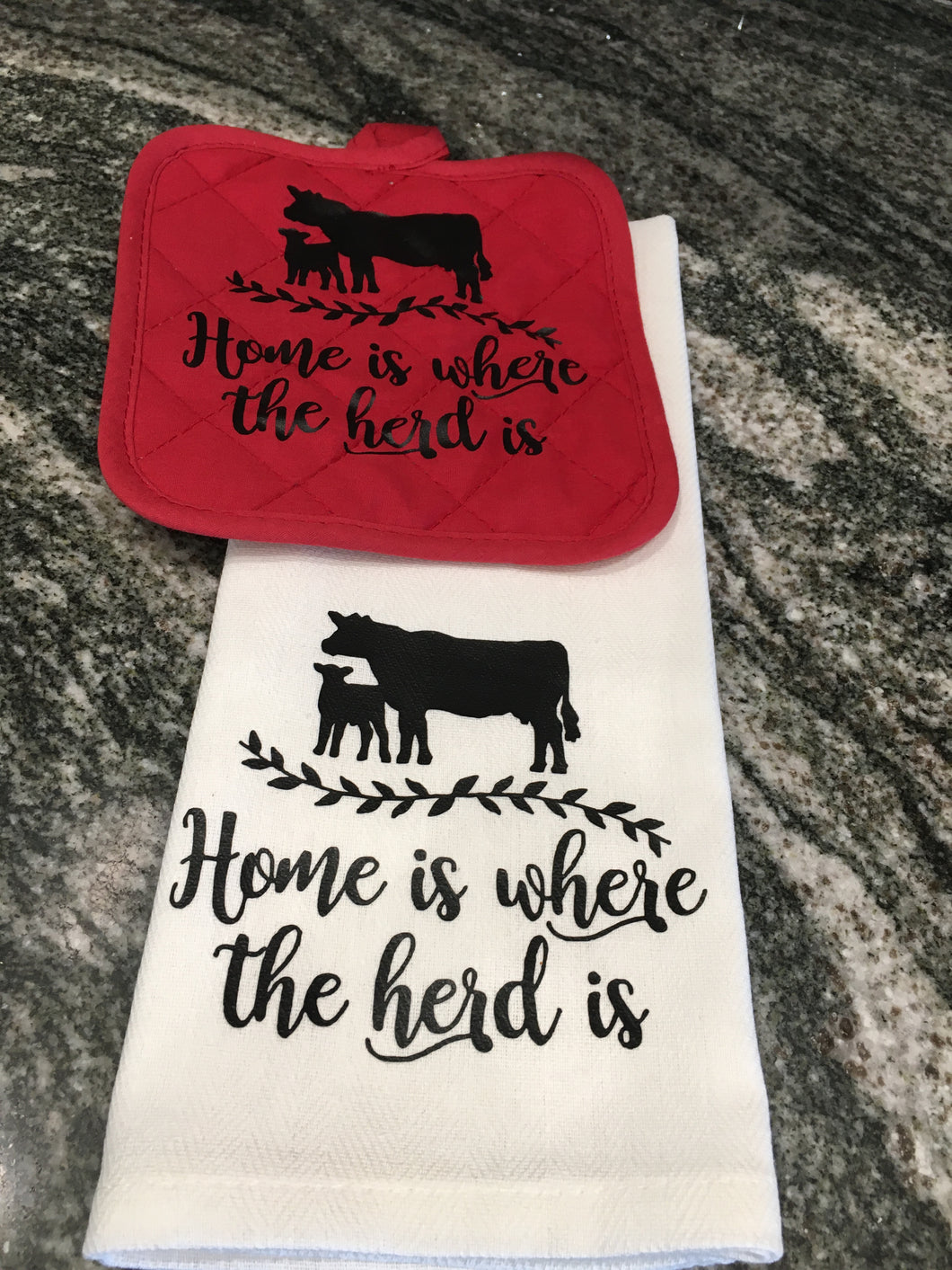 Home is where the herd is cow towel with a red hot pad